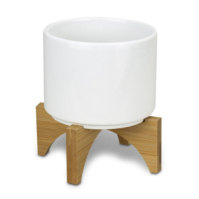 Set of 6 modern ceramic planters with bamboo bases, ideal for indoor plants, enhancing decor with eco-friendly style.