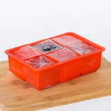 Avanti Silicone 6 Cup King Ice Cube Tray in red, making jumbo ice cubes for drinks, easy to use and clean, versatile for freezing.