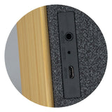Natural bamboo 5W Bluetooth speaker with heather polyester front, offering eco-friendly sound and 6 hours of playtime.