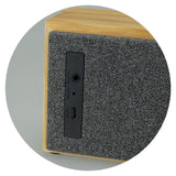 Bluetooth speaker in natural bamboo finish with polyester front, offering 10W power and 6-hour battery life.