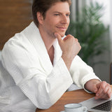 Luxurious white waffle bathrobe with shawl collar, pockets, and 100% cotton fabric for comfort and style. Medium size.