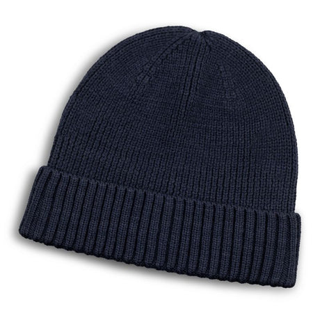 Navy merino wool beanie with a roll-up cuff, offering warmth, comfort, and style for winter wear.