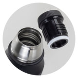 Black stainless steel Wayfarer flask with double-wall vacuum design, screw-on cup, and carry handle, packaged in a sleek gift box.