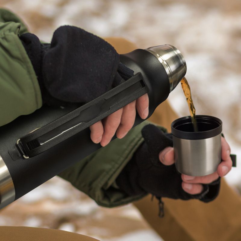 Black stainless steel Wayfarer flask, 1L capacity, double-wall vacuum, screw-on cup, carry handle, perfect for outdoor adventures.