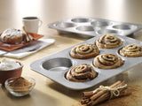 Mini round cake pan with six wells, perfect for baking individual cakes; features non-stick coating and durable construction.