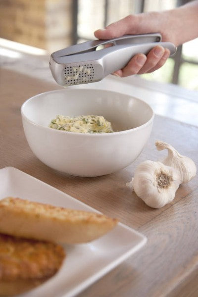 Zyliss Garlic Press Susi 3 with ergonomic handles, minuses waste, includes cleaning tool, and strips garlic peel efficiently.