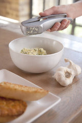 Zyliss Garlic Press Susi 3 with ergonomic handles, minuses waste, includes cleaning tool, and strips garlic peel efficiently.