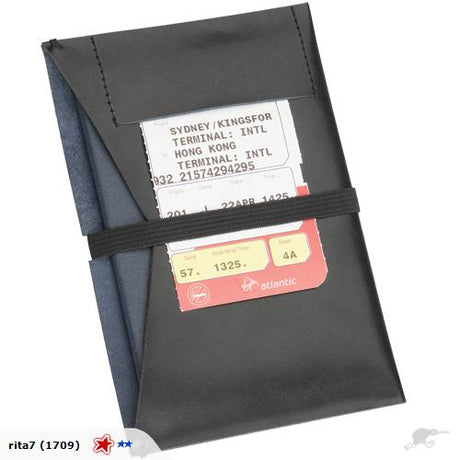 Elegant leather passport holder with elastic closure; compact size for stylish and secure travel organization.