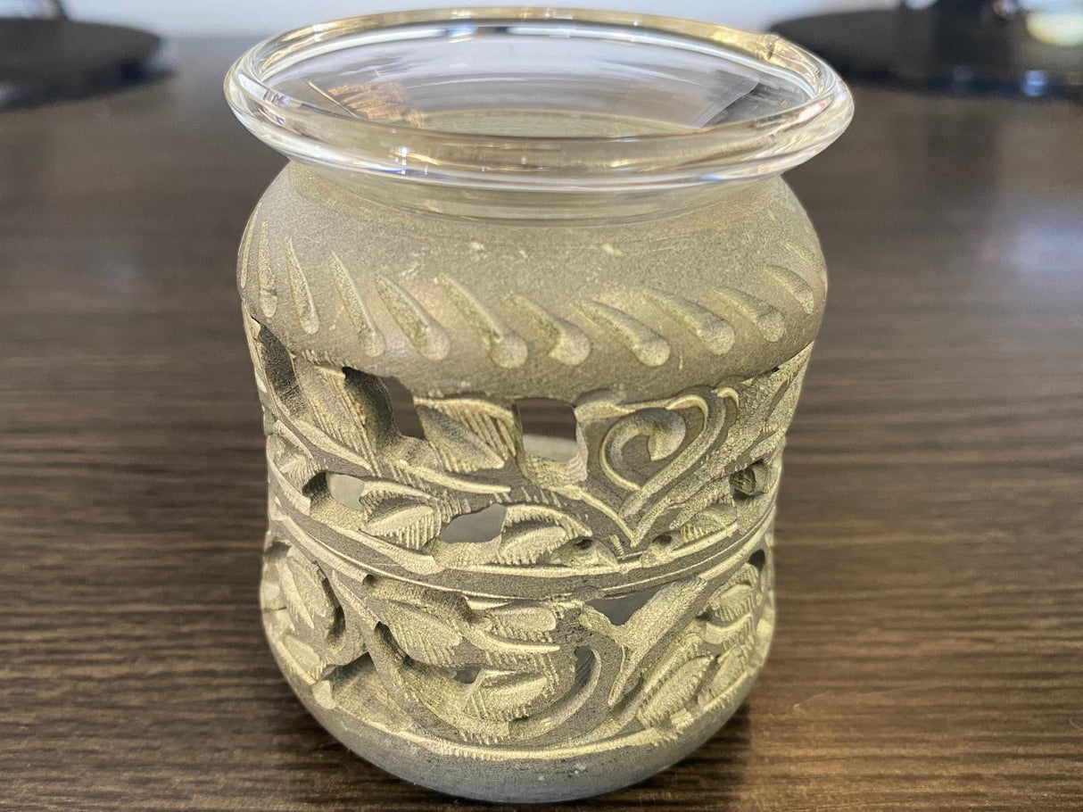 Elegant soapstone aroma therapy oil burner with intricate carvings, perfect for creating relaxing ambiance with essential oils.