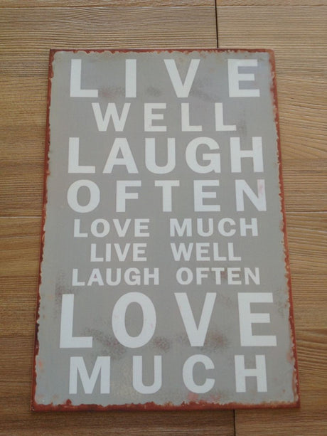 Inspirational metal wall art sign with vintage design, featuring "Live Well, Laugh Often, Love Much," perfect for any room.