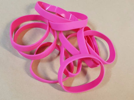 Vibrant pink silicone wristbands in a pack of 10, perfect for events, promotions, and raising awareness.