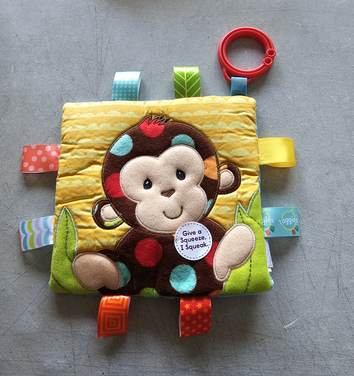 Colorful Taggies Crinkle Monkey Toy with soft textures, crinkle sounds, and interactive tags for sensory play and motor skill development.
