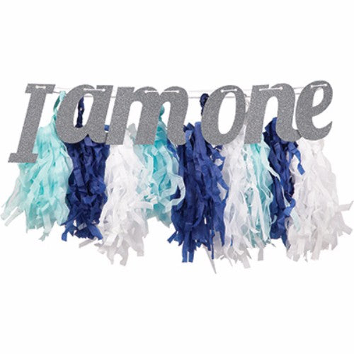 High chair decoration kit in blue, featuring 'I am One' banner and tissue fringe for a vibrant 1st birthday celebration.
