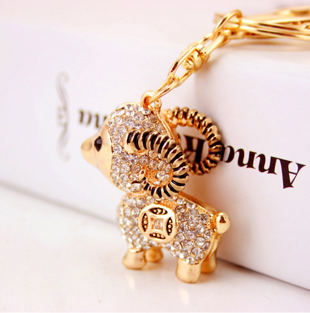 Sparkling sheep-shaped key ring adorned with diamantes, perfect for adding charm and elegance to your key collection.