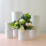 Elegant round white flower box set of 7, perfect for floral arrangements or chic storage, measuring 25x25cm each.
