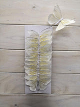 Colorful set of 12 artificial butterflies made from feathers, featuring flexible wire bodies for versatile decorating options.