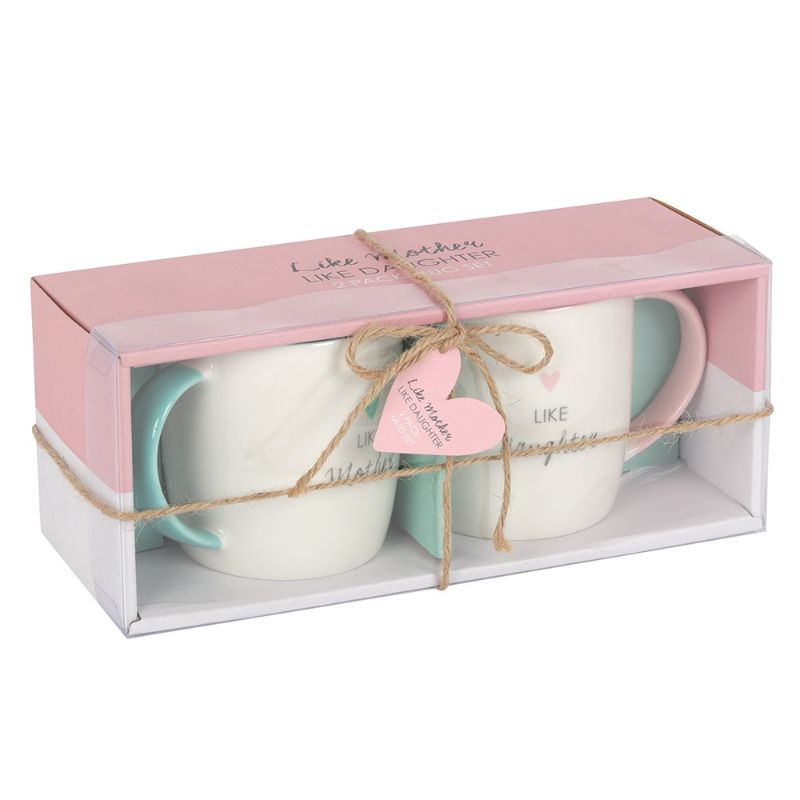 Ceramic mug set in pastel teal and pink, featuring 'Like Mother' and 'Like Daughter' inscriptions, celebrating their bond.