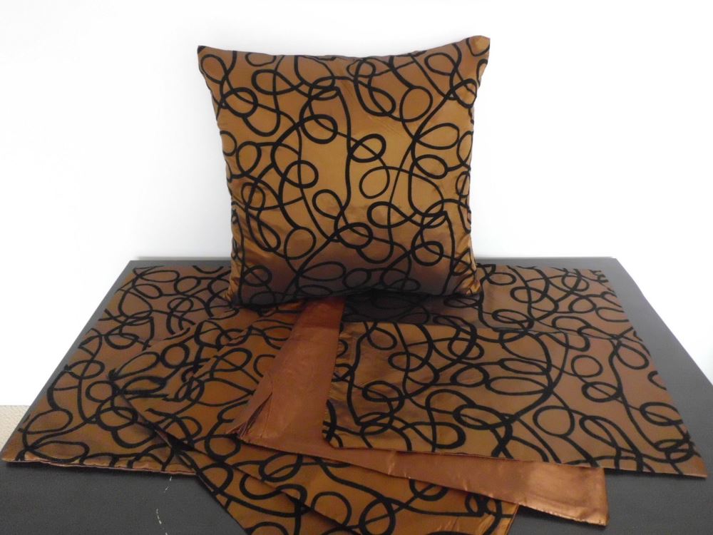 Set of 5 stylish brown cushion covers with textured black squiggle design, reversible for versatility and easy zip closure.