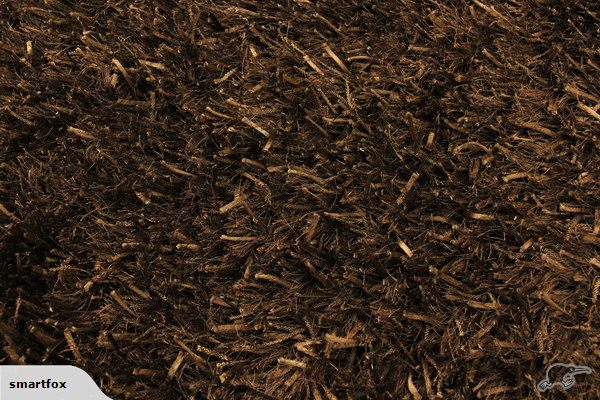 Handmade shaggy rug in rich brown, 1.6 x 2.3m, offering plush comfort and elegant texture for any living space.