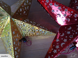 Three vibrant red star lanterns, 45cm, designed to illuminate with patterns, perfect for parties or decor.