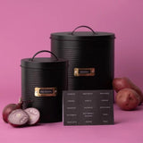 Stylish black ribbed canister set for root vegetables with gold accents and ventilation holes, includes labels for organization.