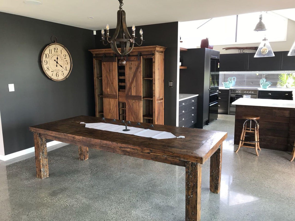 Rustic bar and wine unit with sliding doors, made of reclaimed pine, featuring ample storage for bottles and glasses.