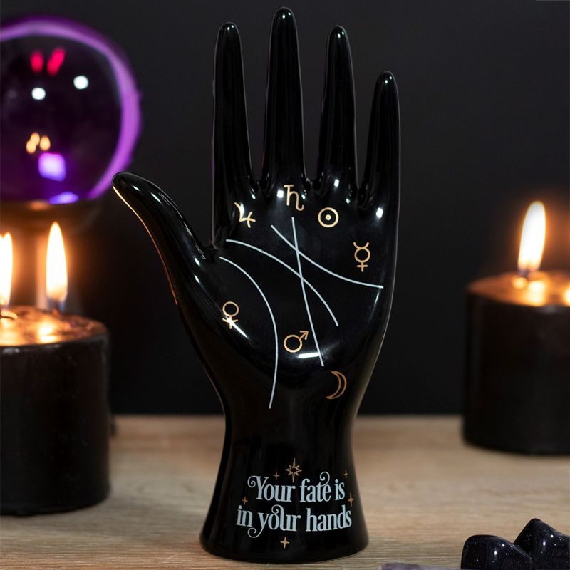 Black ceramic palmistry hand ornament with metallic gold symbols, featuring "Your fate is in your hands" inscription.