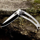 Compact stainless steel folding knife with keyring, features a lock for safety, and a sleek minimalist design.