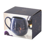 Handcrafted blue mug featuring crescent moons and stars, accented with gold foil; perfect for tea and coffee lovers.