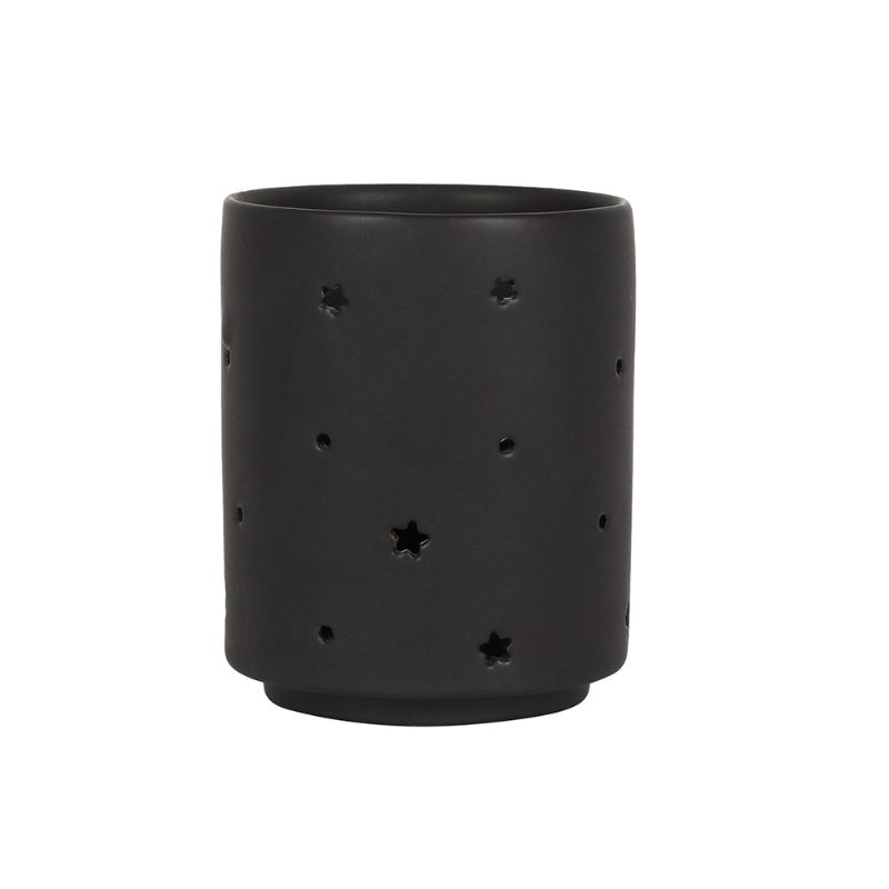 Small black ceramic tealight holder with moon and star cut-out design, perfect for creating a cozy, mystical ambiance.