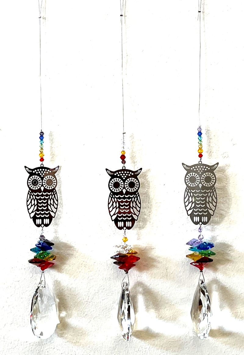 Colorful set of 12 owl suncatchers, crafted to refract light and create vibrant rainbows in any space.