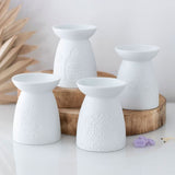 White ceramic oil burner with Tree of Life design, perfect for fragrances and creating a calming atmosphere.