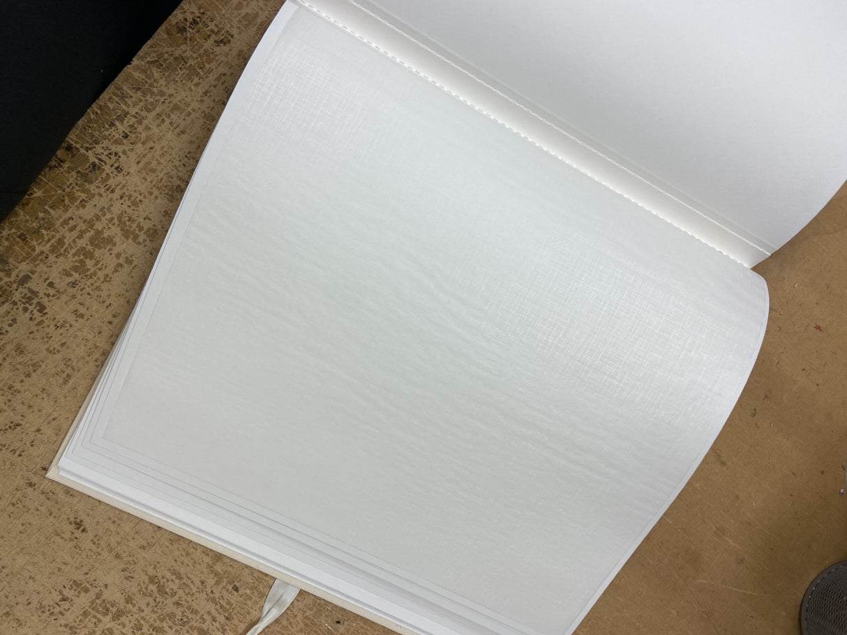 Luxurious white post-bound photo album for 40 photos, crafted in Germany with acid-free materials for lasting memory preservation.