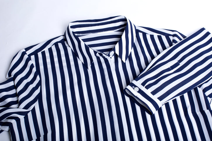Navy long sleeve shirt for women, featuring a luxe touch, semi-fitted silhouette, and inverted back pleat for a polished look.