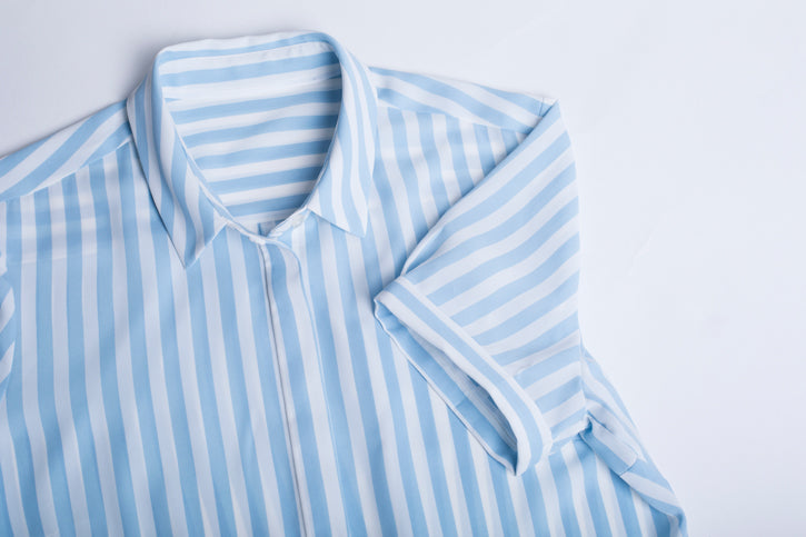 Purple Reign women's short sleeve shirt in a semi-fitted style, featuring a hidden button placket and inverted back pleat.