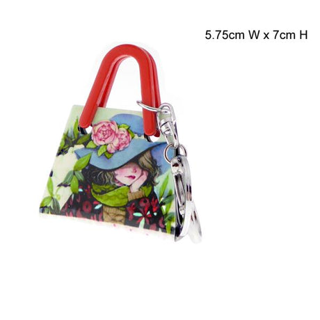 Charming acrylic keyring featuring a stylish handbag girl wearing a blue hat, perfect for adding whimsy to your accessories.