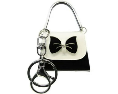 Mini handbag keyring with black and white bow, stylish and functional, perfect for keys or bags.