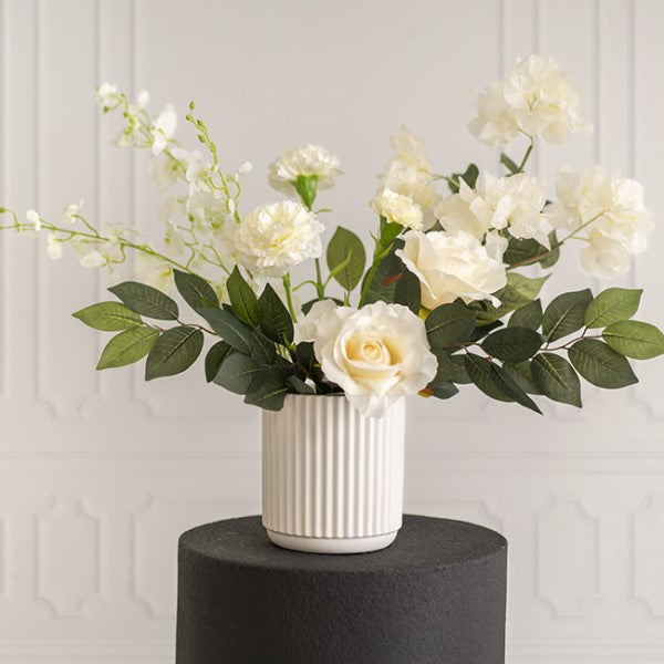 Stylish matte white ceramic vase, 14D x 15cmH, ideal for flowers or as a decorative piece in any decor style.