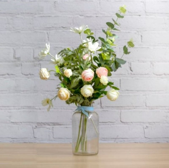 Elegant cream and green artificial Ranunculus spray with three ruffle flower heads and lush foliage, perfect for any decor.