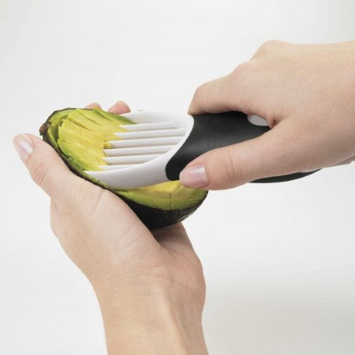 3-in-1 Avocado Slicer featuring a plastic blade, pitting tool, and fan blade for easy slicing and pit removal. Dishwasher safe.