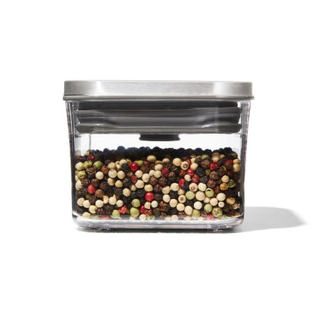 A sleek 0.4L OXO Steel mini storage container with airtight seal, ideal for spices and pantry organization.