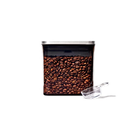 Small stainless steel square coffee storage container with airtight seal and clear base for freshness and visibility.