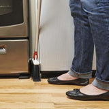 OxO Good Grips Any-Angle Broom with adjustable head and flexible bristles for easy cleaning in tight spaces.