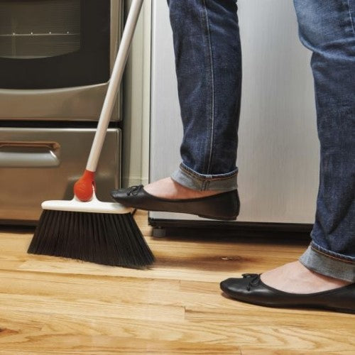 Any-Angle Broom with adjustable head for cleaning tight spaces; features flexible bristles for thorough dust sweep.