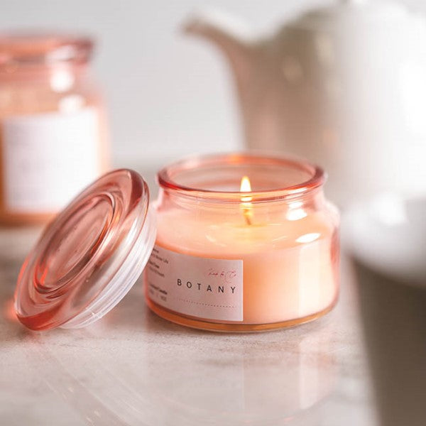 Scented candle in a botany jar featuring pink rose and water lily scents, perfect for creating a serene ambiance.