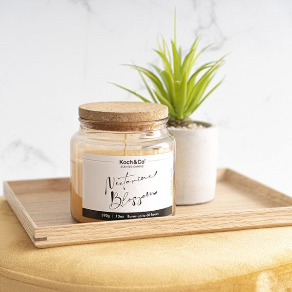 Scented Candle in Nordic jar, infused with ripe nectarines, offering 60 hours of citrusy aroma for relaxation and ambiance.