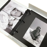 Elegant large photo album with black pages, natural cloth cover, and embossed text for preserving cherished memories.