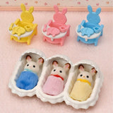 Adorable Chocolate Rabbit triplets in colorful outfits with accessories for nurturing play, including baby furniture and blankets.