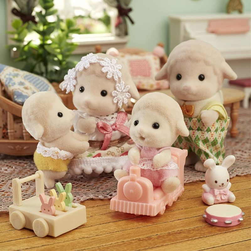 Adorable Sylvanian Families Sheep Twins, Sean and Shona, with a toy train for imaginative adventures and play.