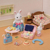 Sylvanian Families Weekend Travel Set featuring Emilia Snow Rabbit with suitcase, handbag, and travel accessories for imaginative play.